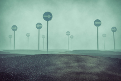 Confused foggy landscape with traffic signs.