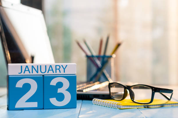 istock January 23rd. Day 23 of month, calendar on student workplace background. Winter time. Empty space for text 908881220