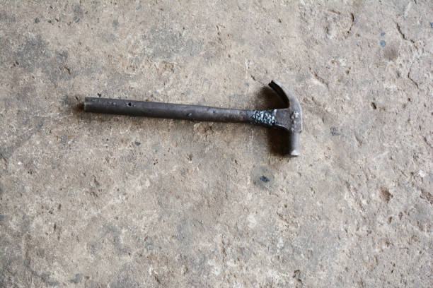 istock old and dirty metal hammer on rough cement ground 908890610