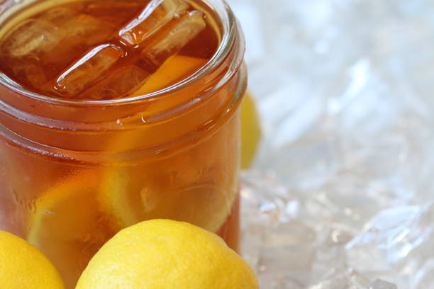 istock Freshly Brewed Ice Cold Sweet Tea with Lemons and Ice Cubes 908891038