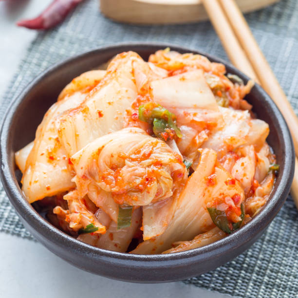 istock Kimchi cabbage. Korean appetizer in a ceramic bowl, square 908893760