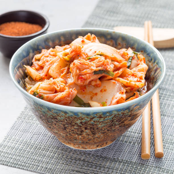 istock Kimchi cabbage. Korean appetizer in a bowl, square 908893784