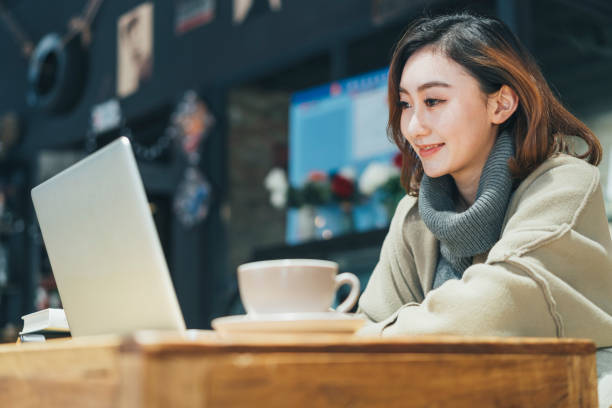 istock young woman looking at laptop,smiling 908894458