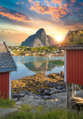 Old Wooden Fishing Barn by the sea on a beautiful and sunny summer day, Lyngen Alps, Norway