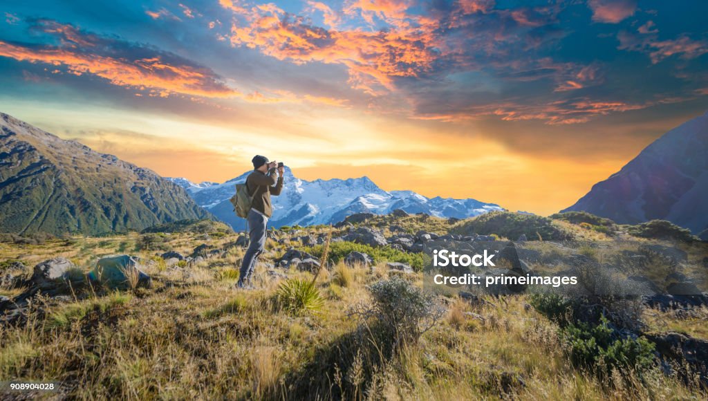 Young traveler taking photo at mt cook famaus destination in new zealand New Zealand Stock Photo