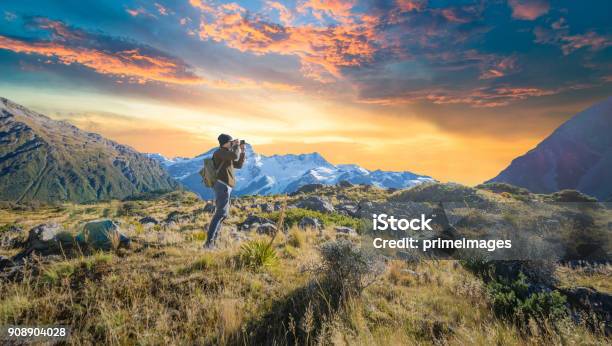 Young Traveler Taking Photo At Mt Cook Famaus Destination In New Zealand Stock Photo - Download Image Now