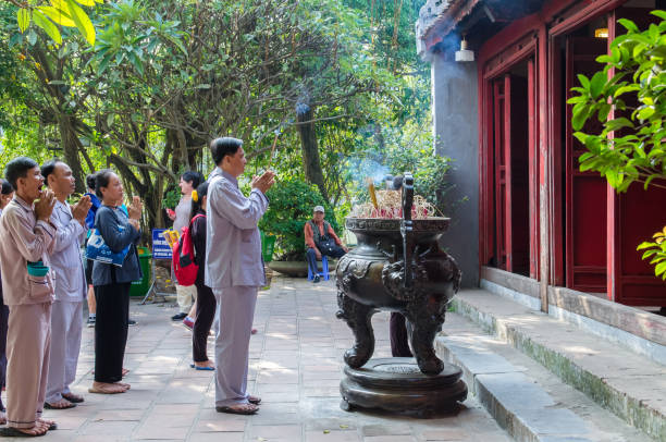 Prayers can seen praying in Ngoc Son Temple in Hanoi,Vietnam. stock photo
