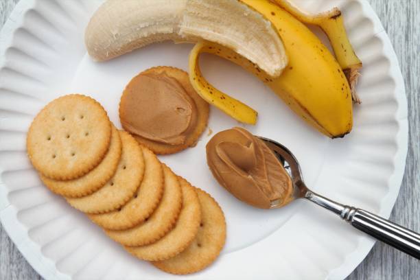 istock Peanut butter snack with banana and crackers 908907000