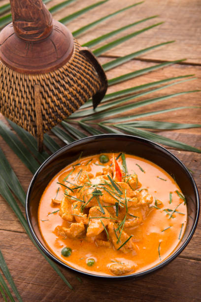 istock Thai curry red soup,Thailand tradition red curry with beef,pork or chicken menu in thai name is panaeng.Curry menu with coconut milk.Panaeng Curry on Wooden table 908907386