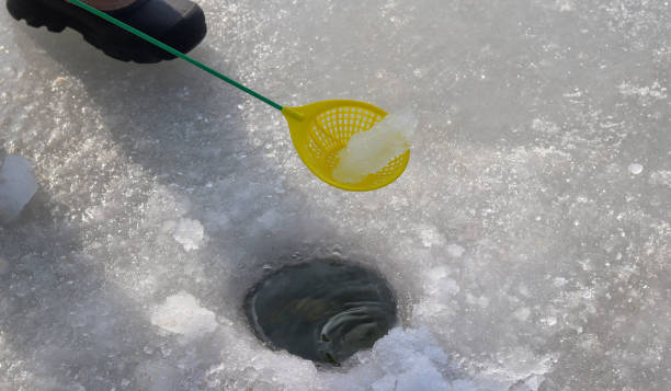 istock Ice fishing at lake. 908913814