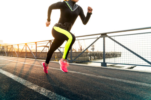 istock young female running against twilight sky 908936180