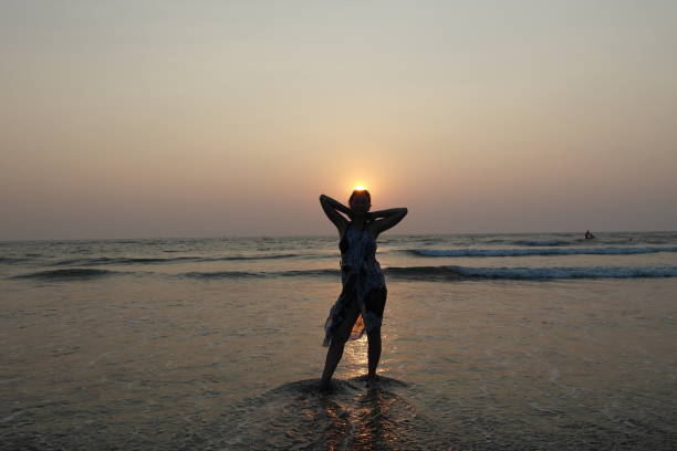 Girl and sun The beautiful girl holds the sun falling in the sea in palms religion sunbeam one person children only stock pictures, royalty-free photos & images