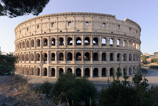 The ancient Roman amphitheater appears complete in the sunrise, with no visible people, from the terrace of Monte Oppio, a touristic popular spot.