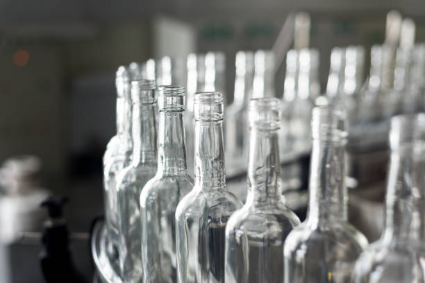 istock Empty glass bottles on the conveyor 908948970