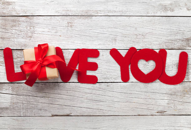 istock Valentines day greeting card with love word and gift 908951664