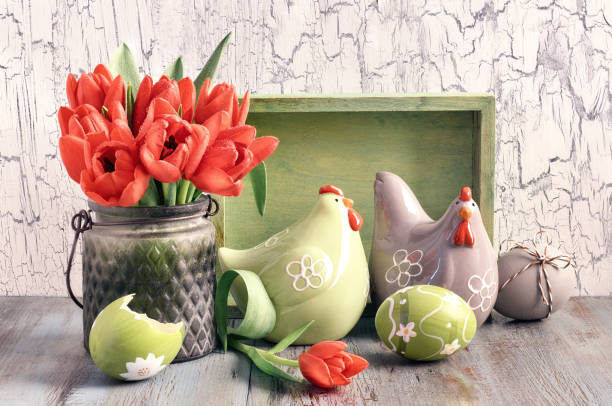 istock Easter composition with red tulips; ceramic hens and Easter eggs on wood 908953218
