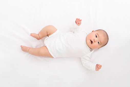 Baby on white sheets