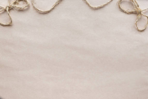 istock beige craft paper background with twine bow copy space 908957190