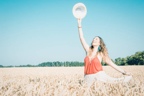 istock Young woman having fun in wheat field 908960018