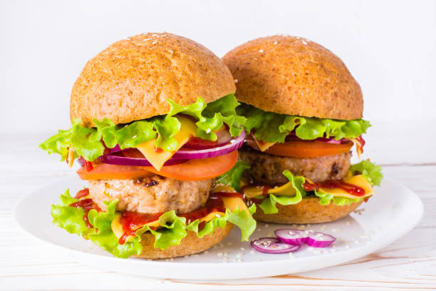 istock Two appetizing hamburgers on a plate 908960260