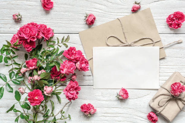 istock blank white greeting card and gift box with pink rose flowers bouquet 908960352