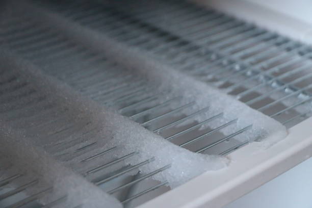 istock freezer compartment with an open door. The freezer covered with snow and ice is open for defrosting. In the refrigerator, snow and ice are melting, frozen on the walls and shelves. 908963376