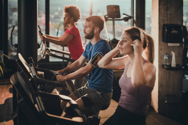 istock Group of athletic people having a exercising class in a gym. 908964138