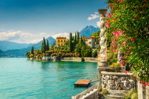 Oleander flowers and villa Monastero in background, lake Como, Varenna Famous luxury villa Monastero, stunning botanical garden decorated with mediterranean oleander flowers, lake Como, Varenna, Lombardy region, Italy, Europe pavilion photos stock pictures, royalty-free photos & images