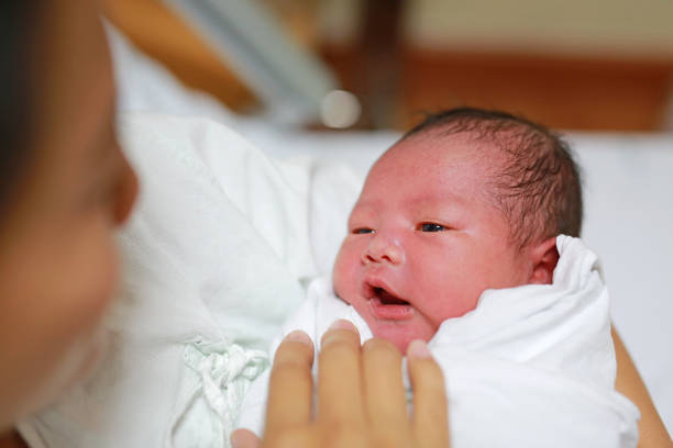 istock Asian mother carrying her baby on her breast. 908964926
