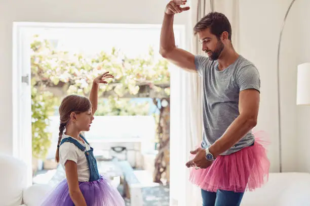 Shot of a father and daughter dancing in their tutus