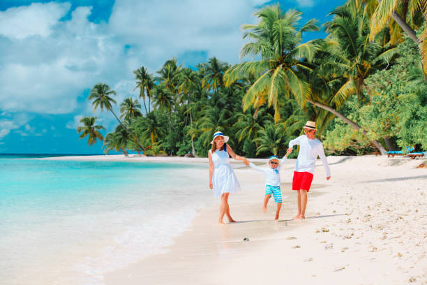 istock family with child playing on beach 908966004