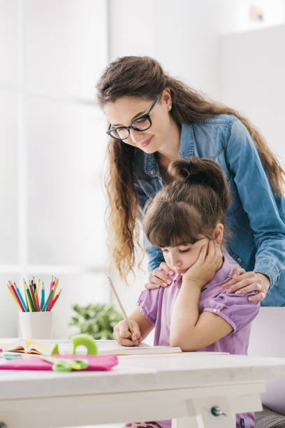 istock Mother and child doing homework together 908966074