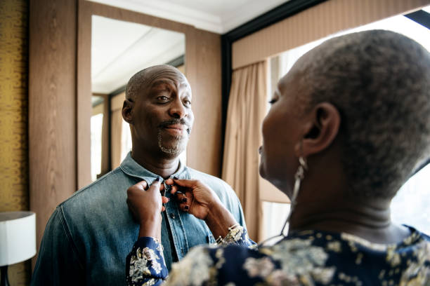 istock Woman helping her partner in dressing up 908968386