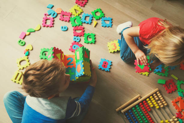 istock kids playing with puzzle, education concept 908970120