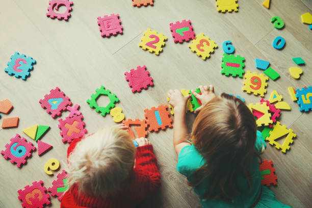 istock kids playing with puzzle, education concept 908970276