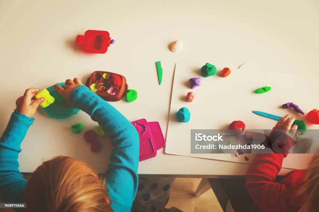 kids play with clay molding shapes kids play with clay molding shapes, kids learning Child Care Stock Photo