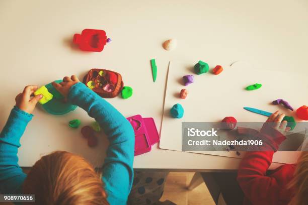 Kids Play With Clay Molding Shapes Stock Photo - Download Image Now - Child Care, Child, Indoors