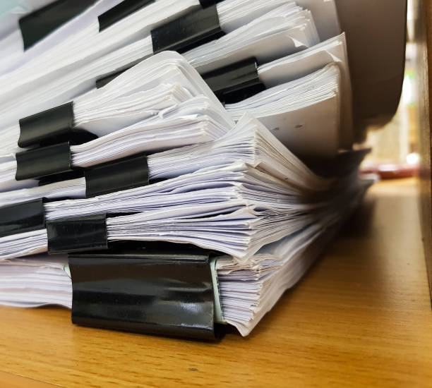 istock Paper Document with Black Binder clip on office c background. 908970906