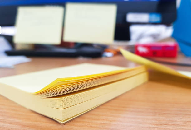 istock yellow paper note design in the desk,office design concept. 908970944