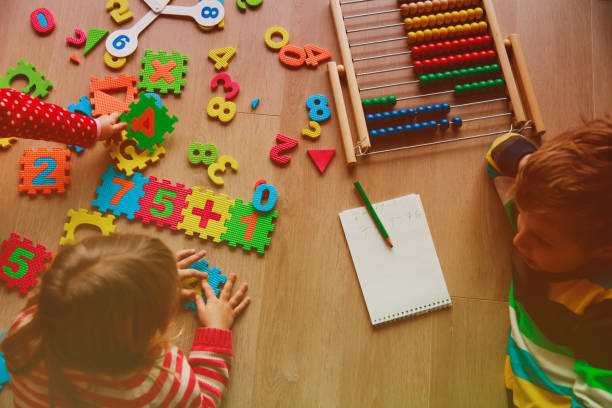 istock little boy and girl learn to calculate numbers 908971082