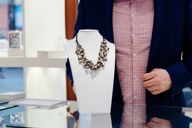 Beautiful Latina artisan from Bogota Colombia between 30 and 34 years old, tries on her latest jewel to send to her client while working from home
