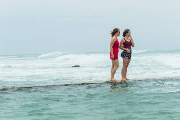 istock Girls Beach Walking Tidal Pool Ocean 908973684