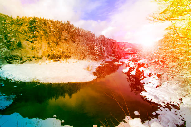 snow landscape mountains trees and river for natural background.