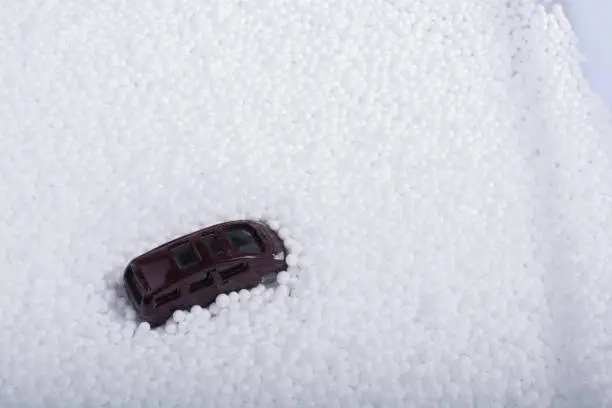 Photo of Model car on white polystyrene foam balls