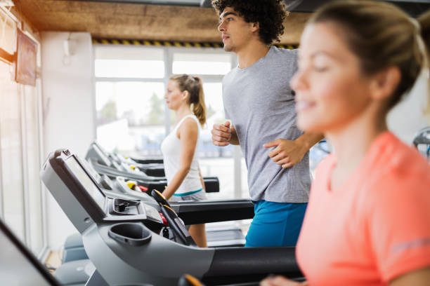 istock Group of friends exercising on treadmill machine 908982032