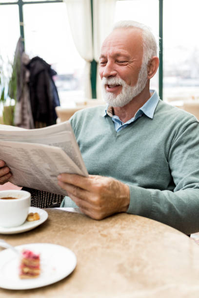istock Senior man with newspaper 908985422