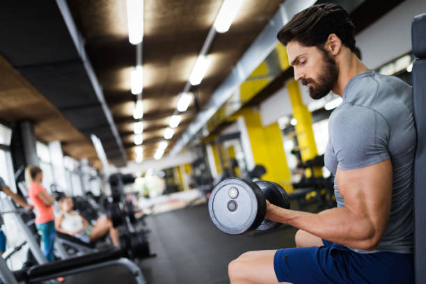 istock Determined male working out in gym 908985540