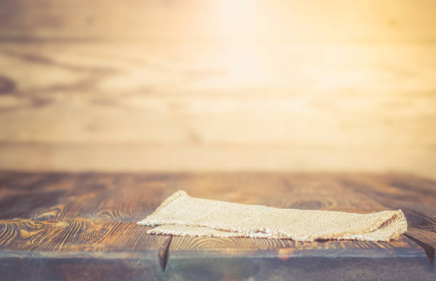 Selective focus is an empty vintage wooden table and wall. For your photo montage or product display. With light effects.