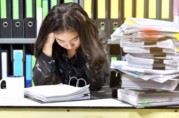 istock Work hard, Lot of work, Stacks of document paper and files folder on office desk, Office worker worried about her messy project. 908985854