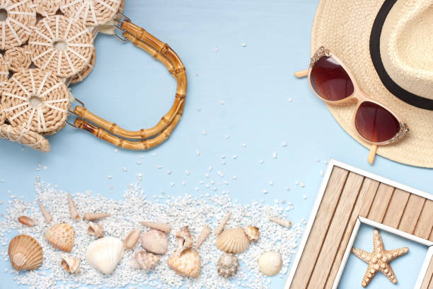 istock Summer accessories, sun glasses   and sea shells on wooden table 908986038